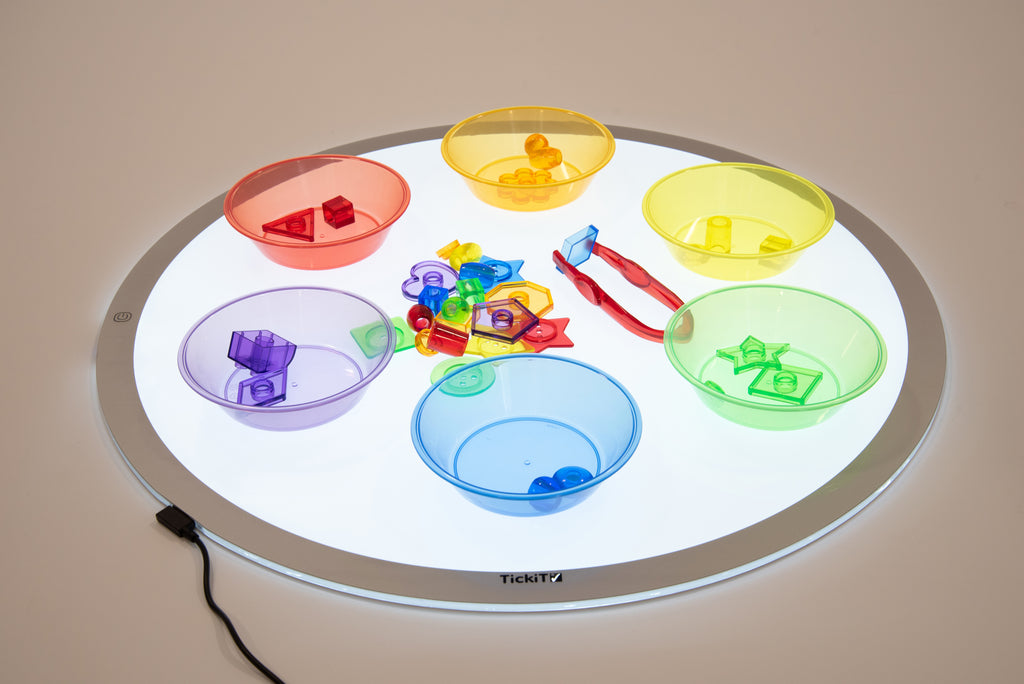 Round LED light panel showing colorful translucent trays on lit white center