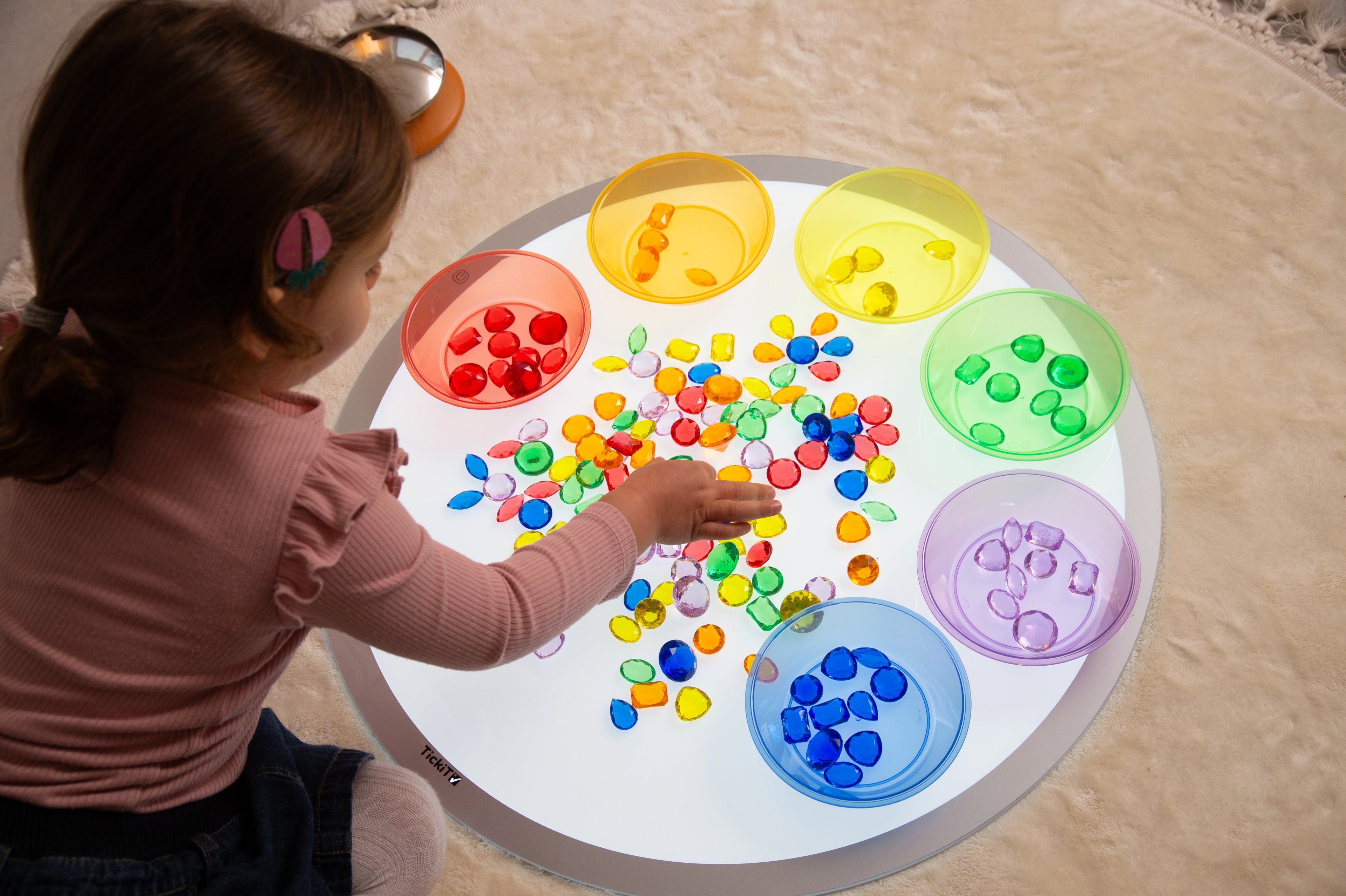 Round LED light panel with bright white surface and colorful circular sections