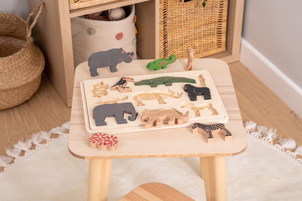 Safari animal puzzle on a tabletop with layered animal pieces in a wooden set
