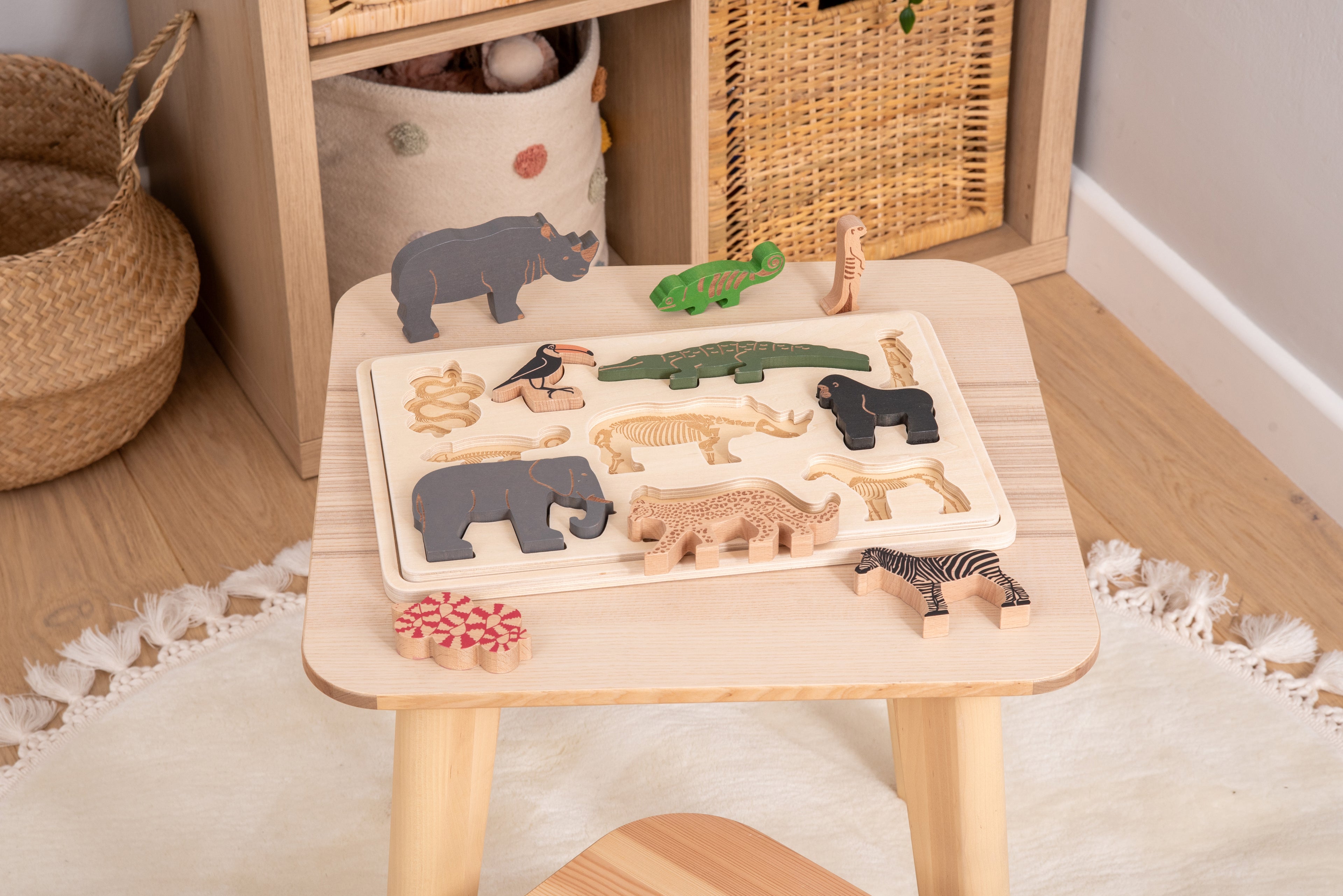 Safari animal puzzle on a tabletop with layered animal pieces in a wooden set