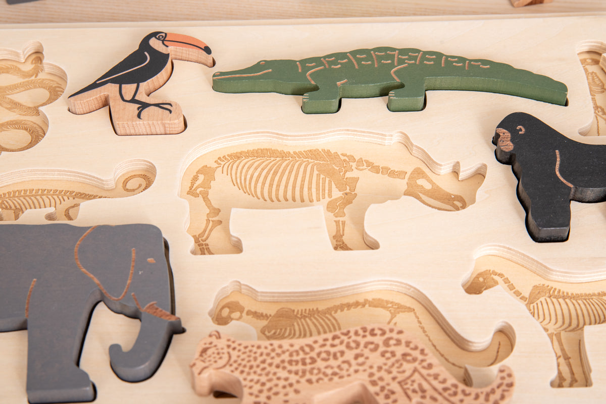 Close-up of safari animal layer puzzle board with large layered animal and bone pieces