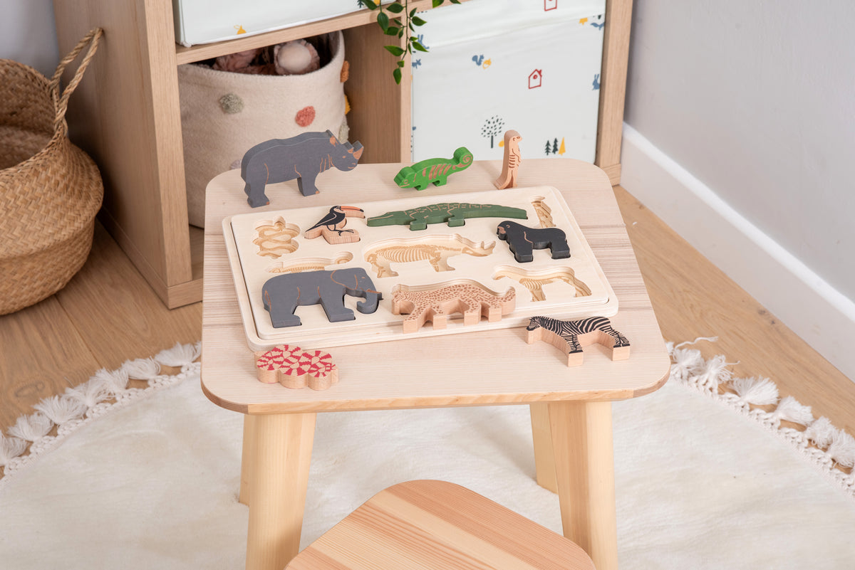Safari animal layer puzzle on a small table with animal pieces on the tray