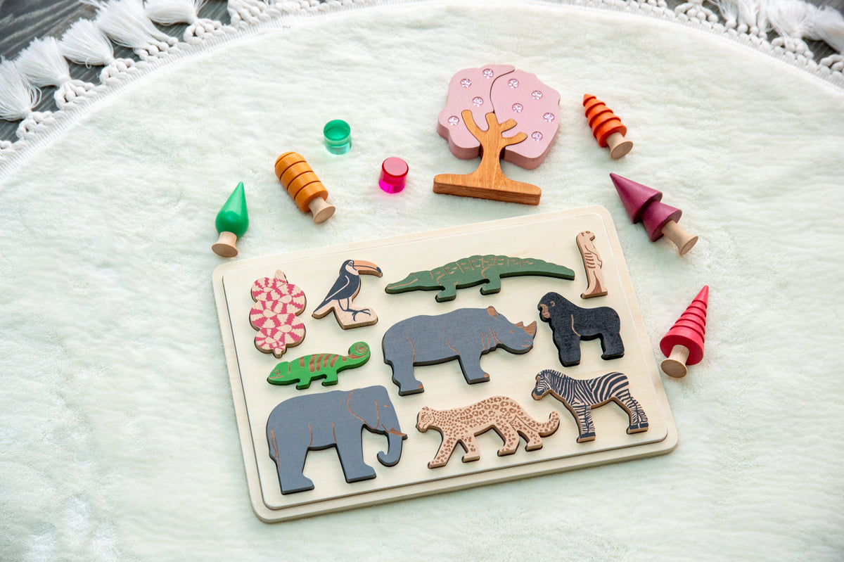Safari animal puzzle board on a soft blanket with scattered colorful animal pieces