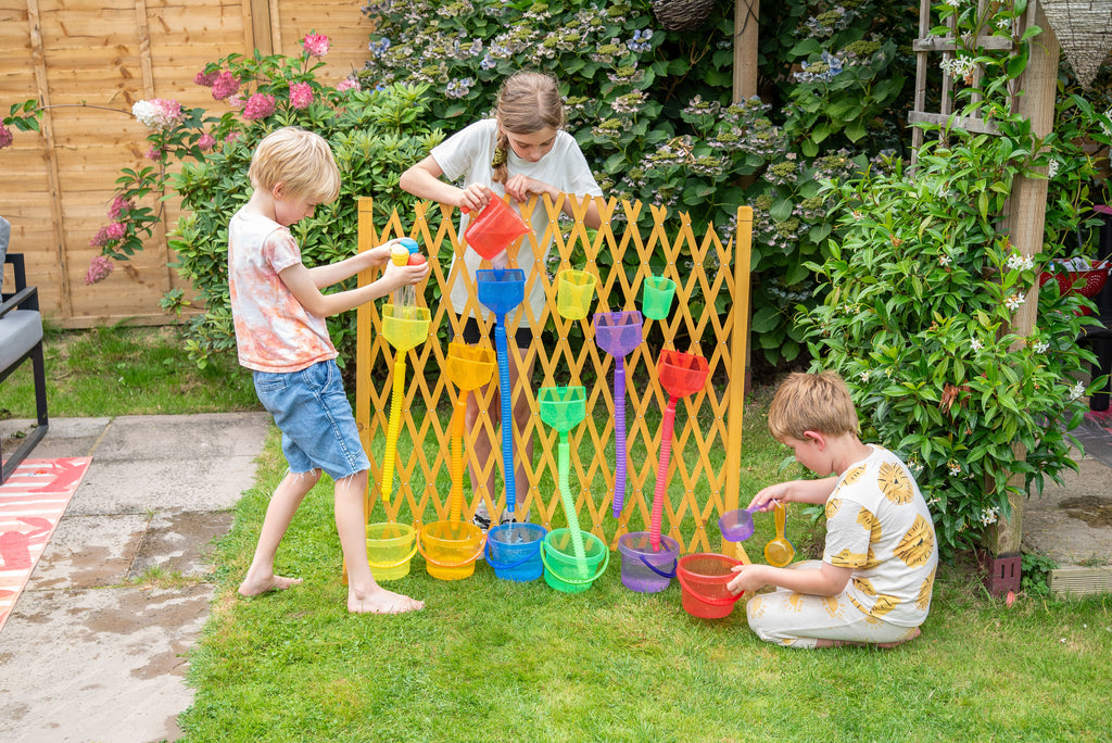 Yellow water play gate with hanging cups; kids pouring water
