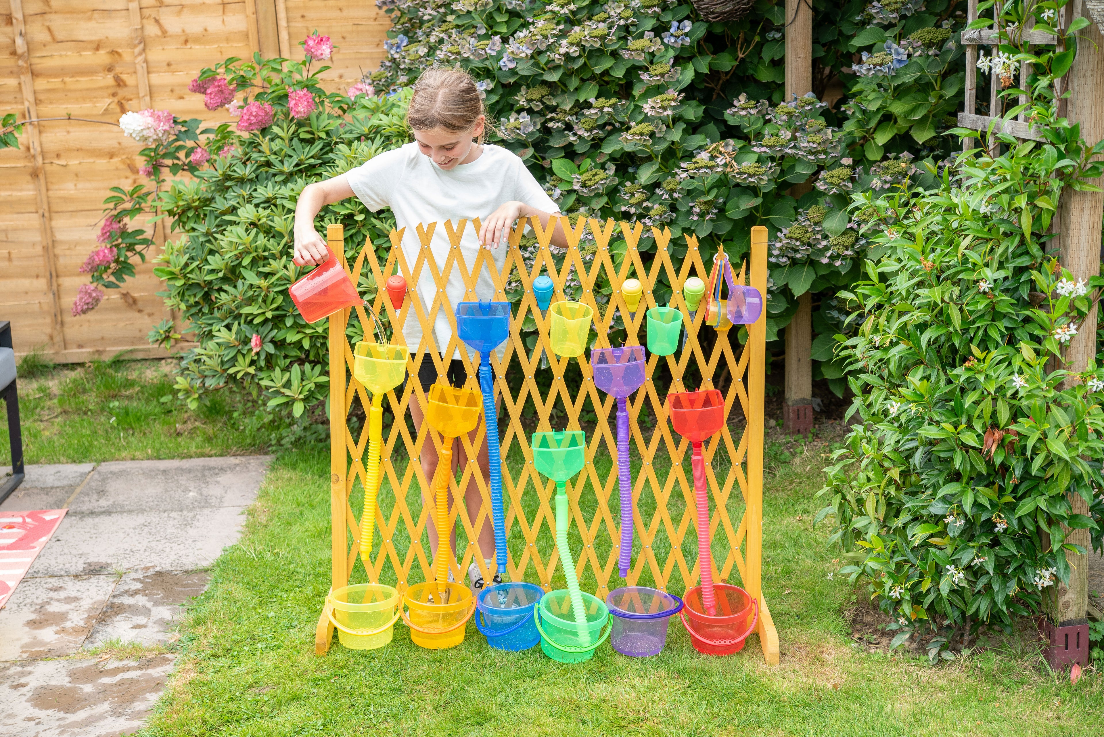 Yellow plastic water play gate with hanging cups and scoops