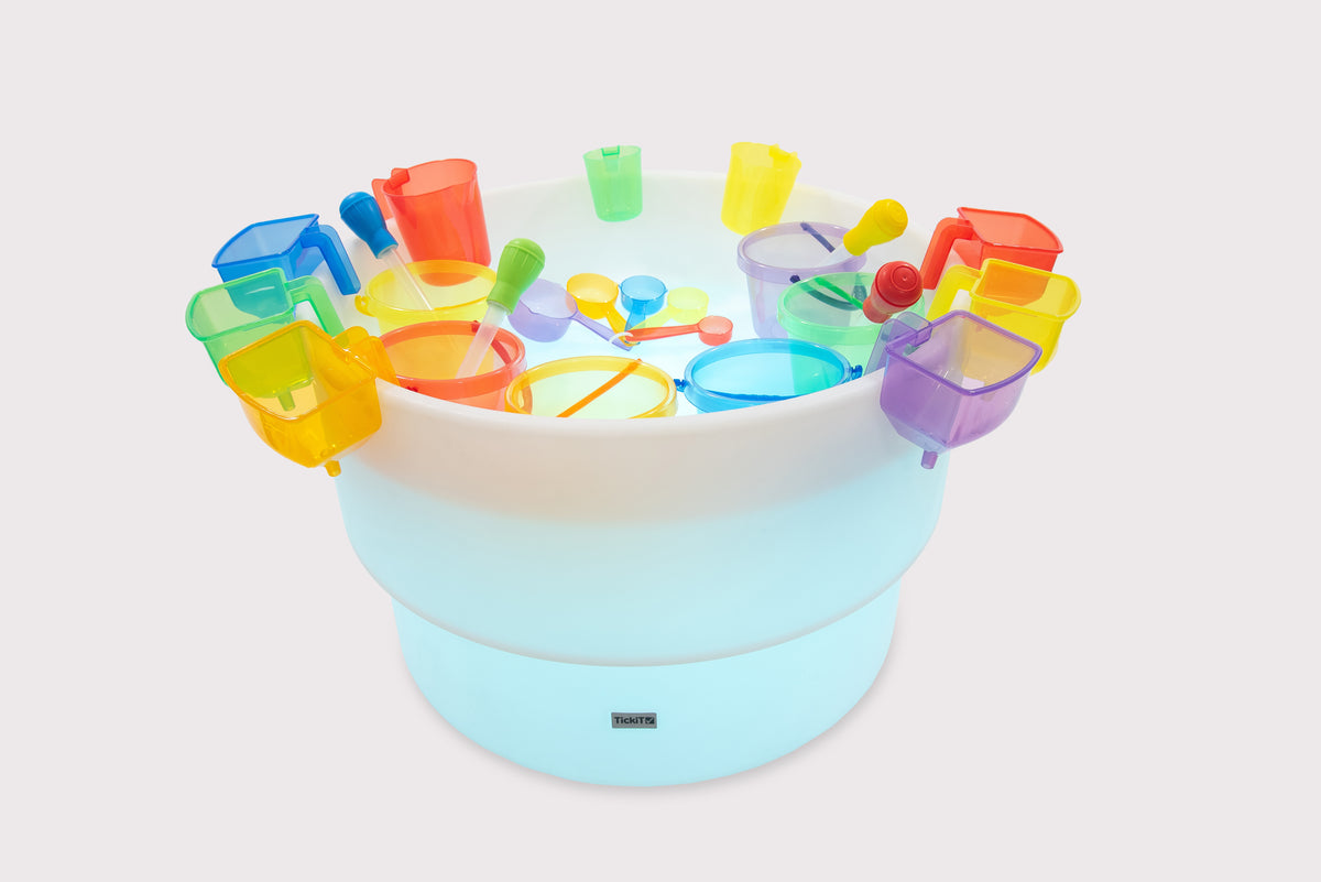 Light round water and sand table with rainbow plastic cups and scoops