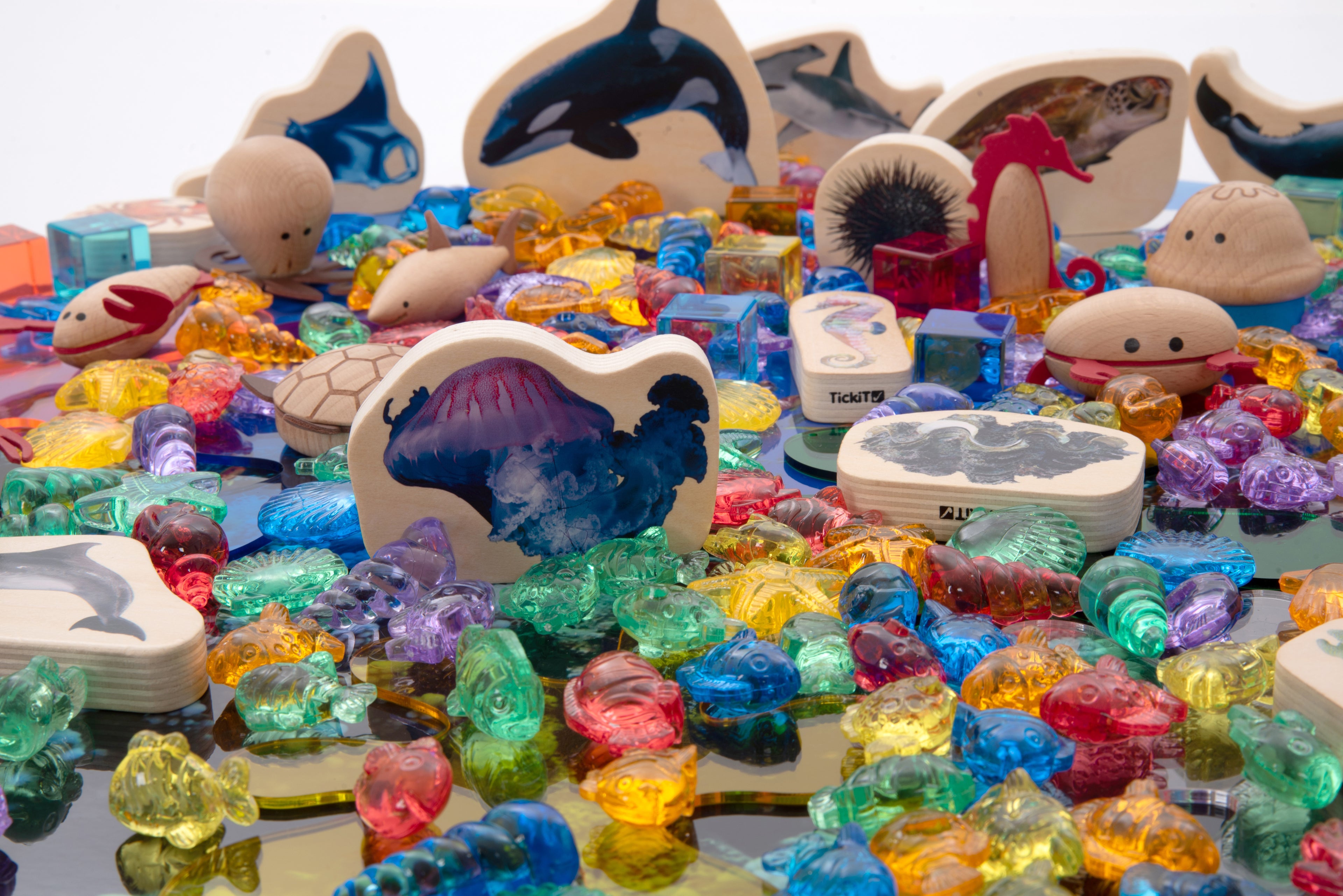 Pile of colorful sea animal figurines and shells in a toy bundle