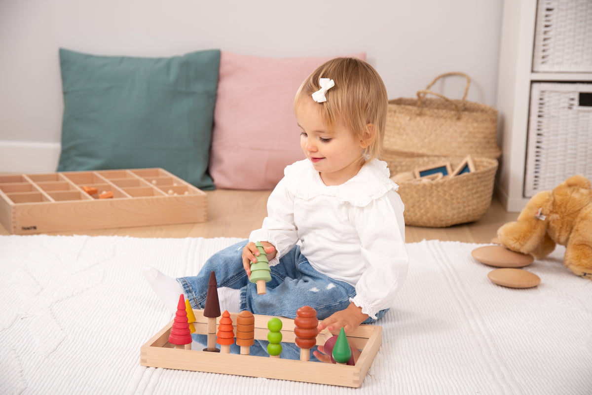 Wooden tree figures on rectangular tray with multicolor designs