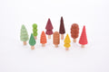 Set of multicolor wooden tree figures with different top shapes