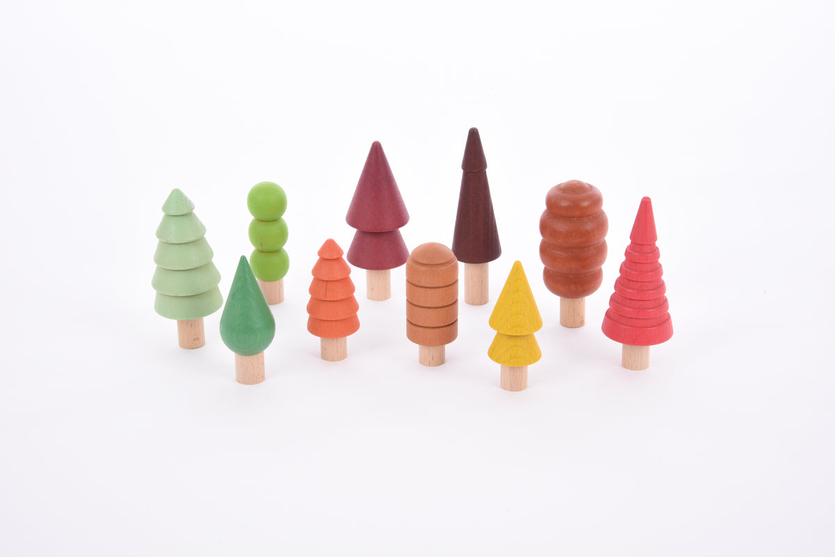 Set of multicolor wooden tree figures with different top shapes