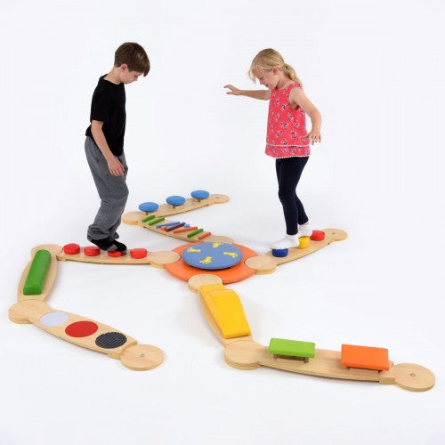 Wooden sensory balance beam set with colorful pads and circular insets for stepping