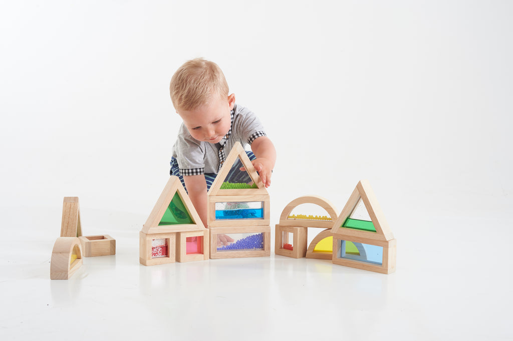 Wooden sensory blocks set with colorful bead inserts, child playing with blocks