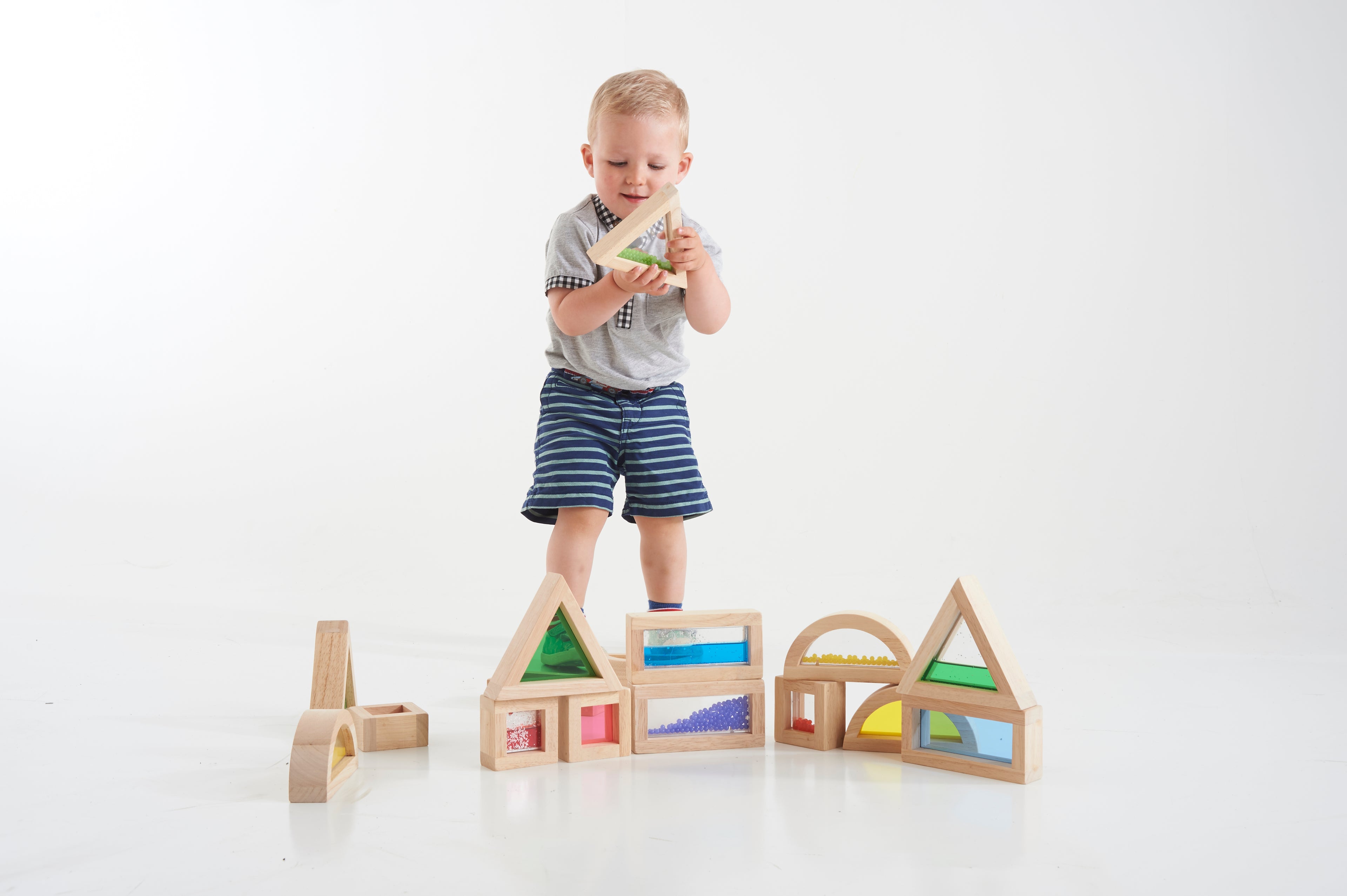 Wooden sensory blocks set with rainbow-colored sliding beads in geometric frames