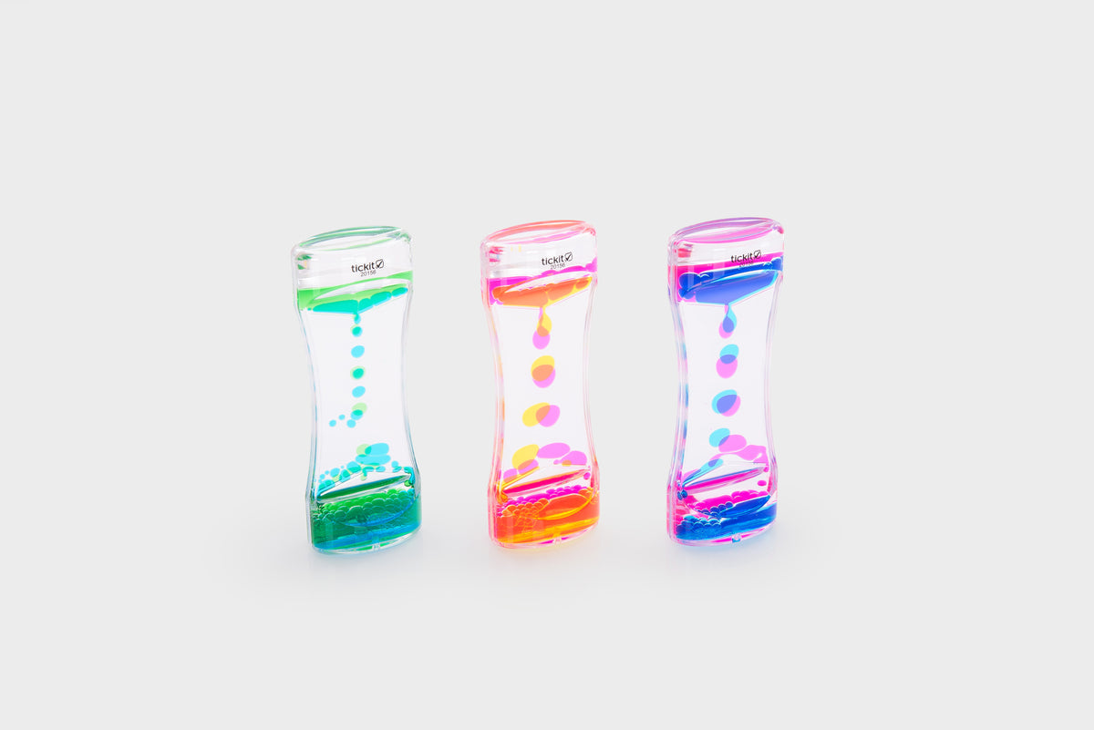 Three translucent rainbow sand timers with colorful bead cascades and blue, pink, green accents