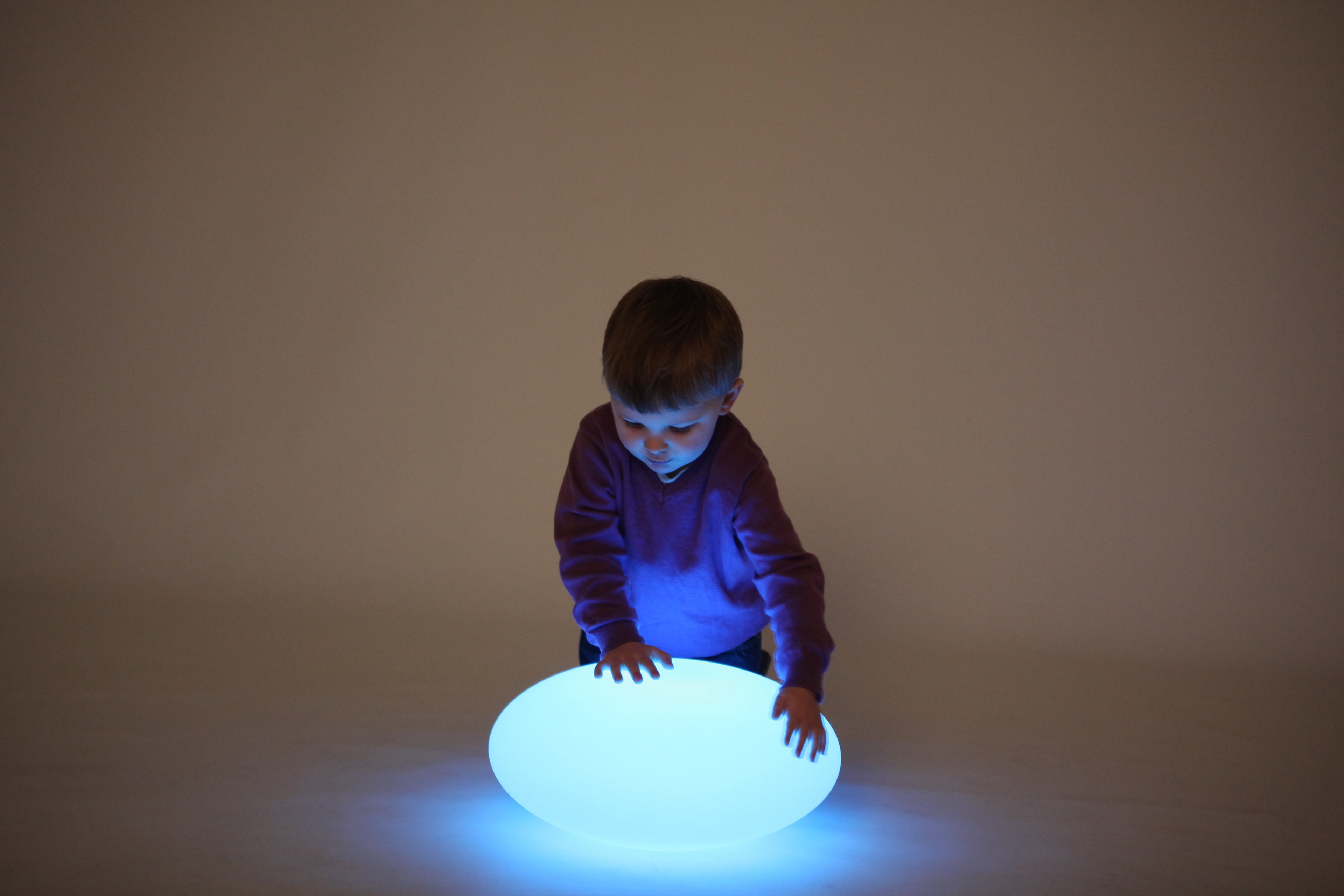 Blue glowing oval pebble light on the floor