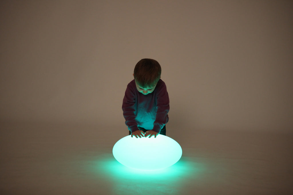 Green-lit oval glow pebble light on the floor