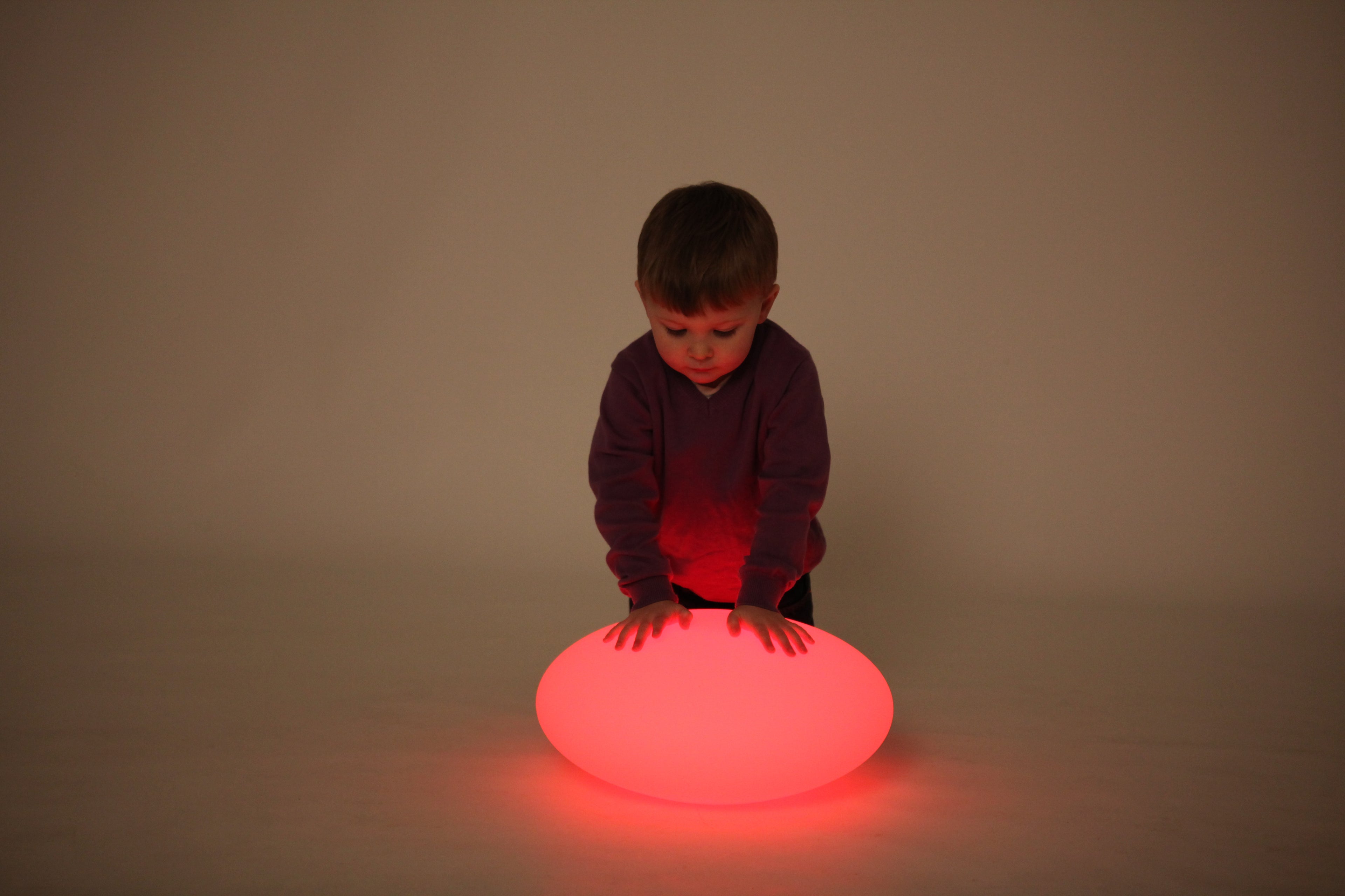 Red glowing oval pebble light on the floor