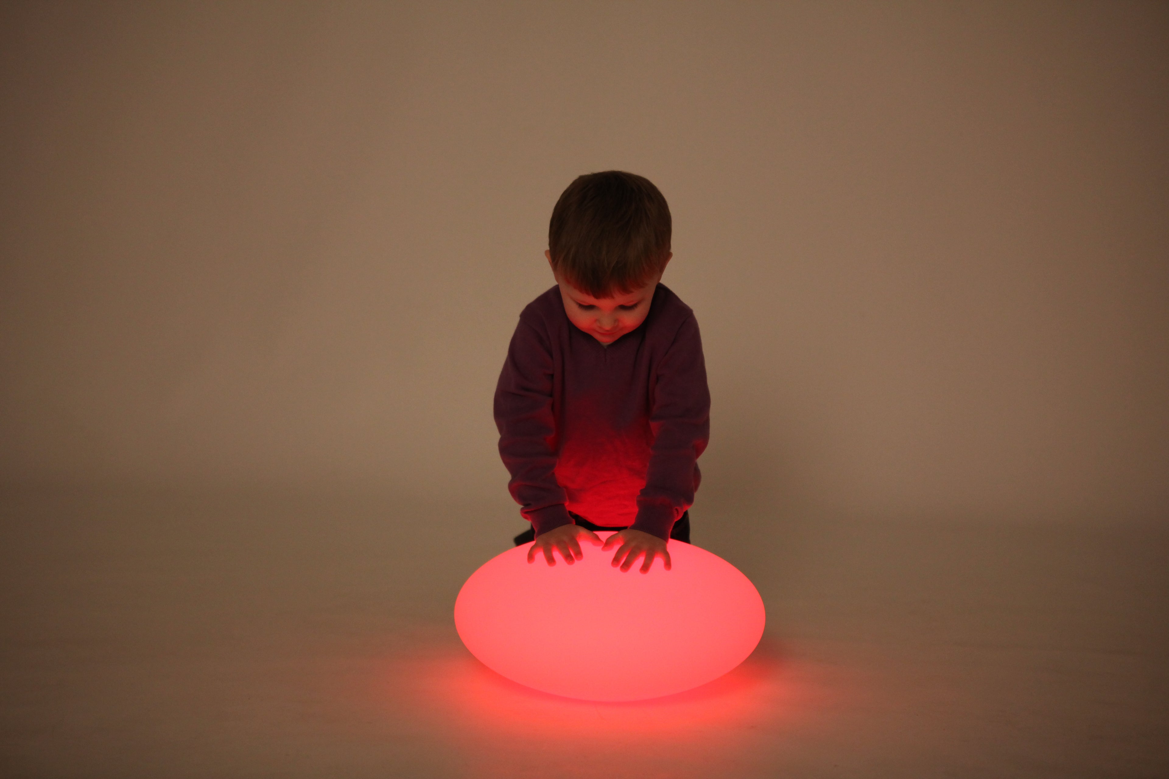 Red glowing oval pebble light on the floor