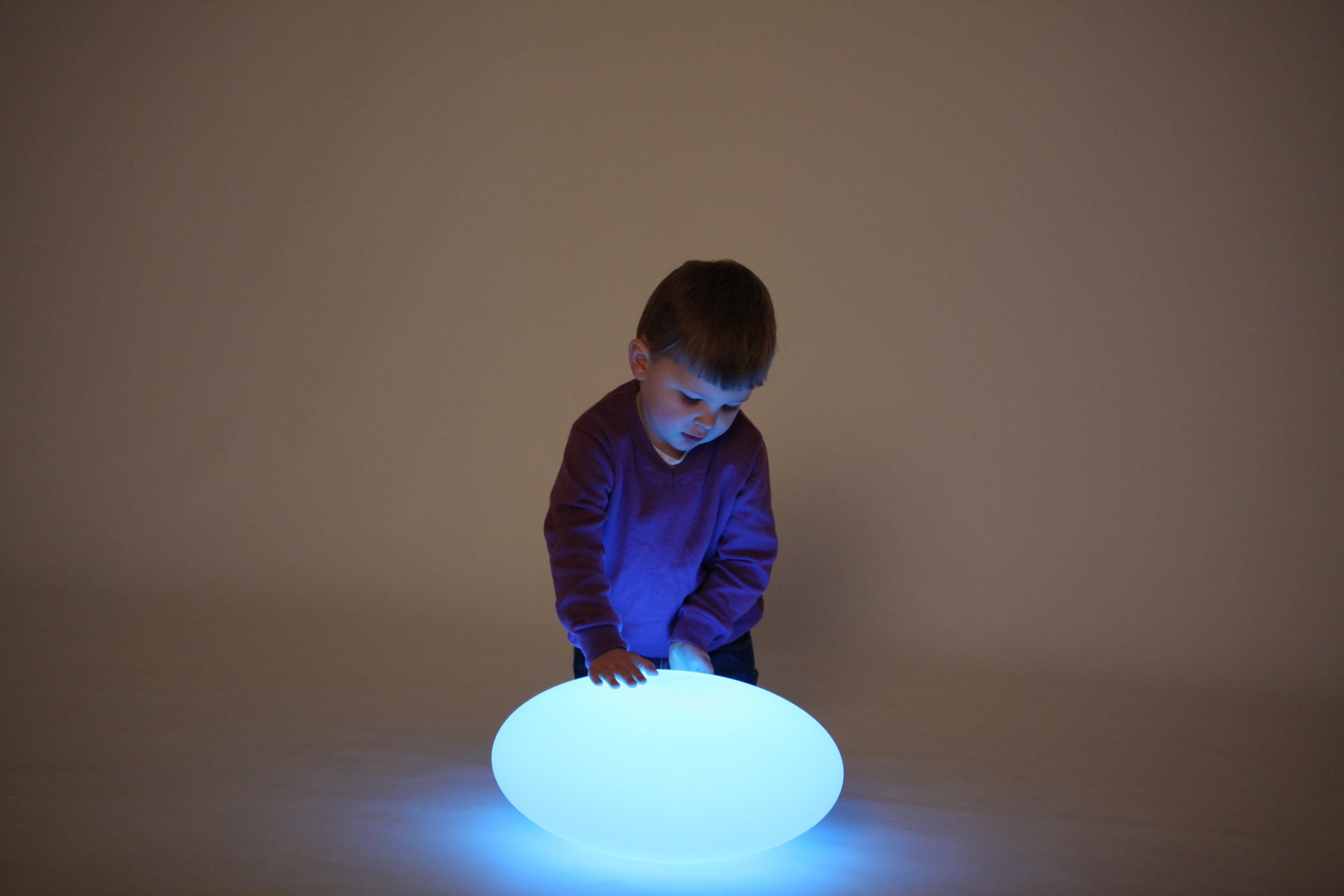 Blue glowing oval pebble light on the floor