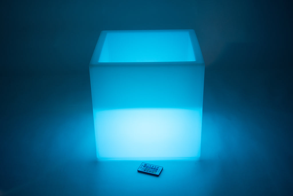 Glowing sensory play cube in blue light, front view