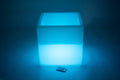 Glowing sensory play cube in blue light, front view