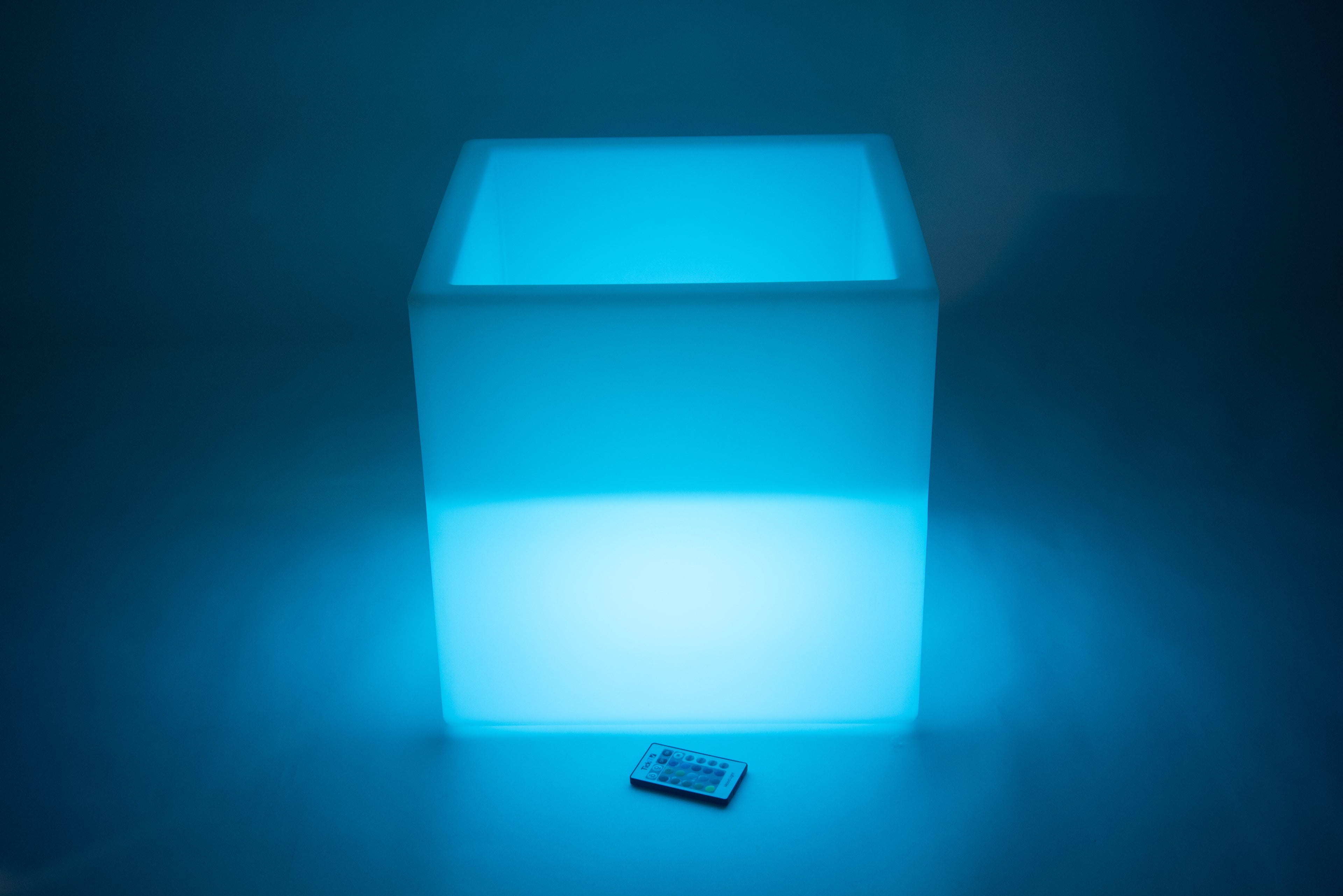 Glowing sensory play cube in blue light, front view