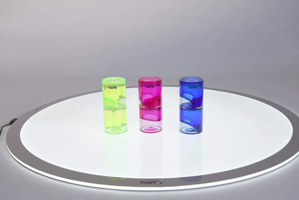 Set of three tickit ooze tubes: green, pink, and blue on round tray