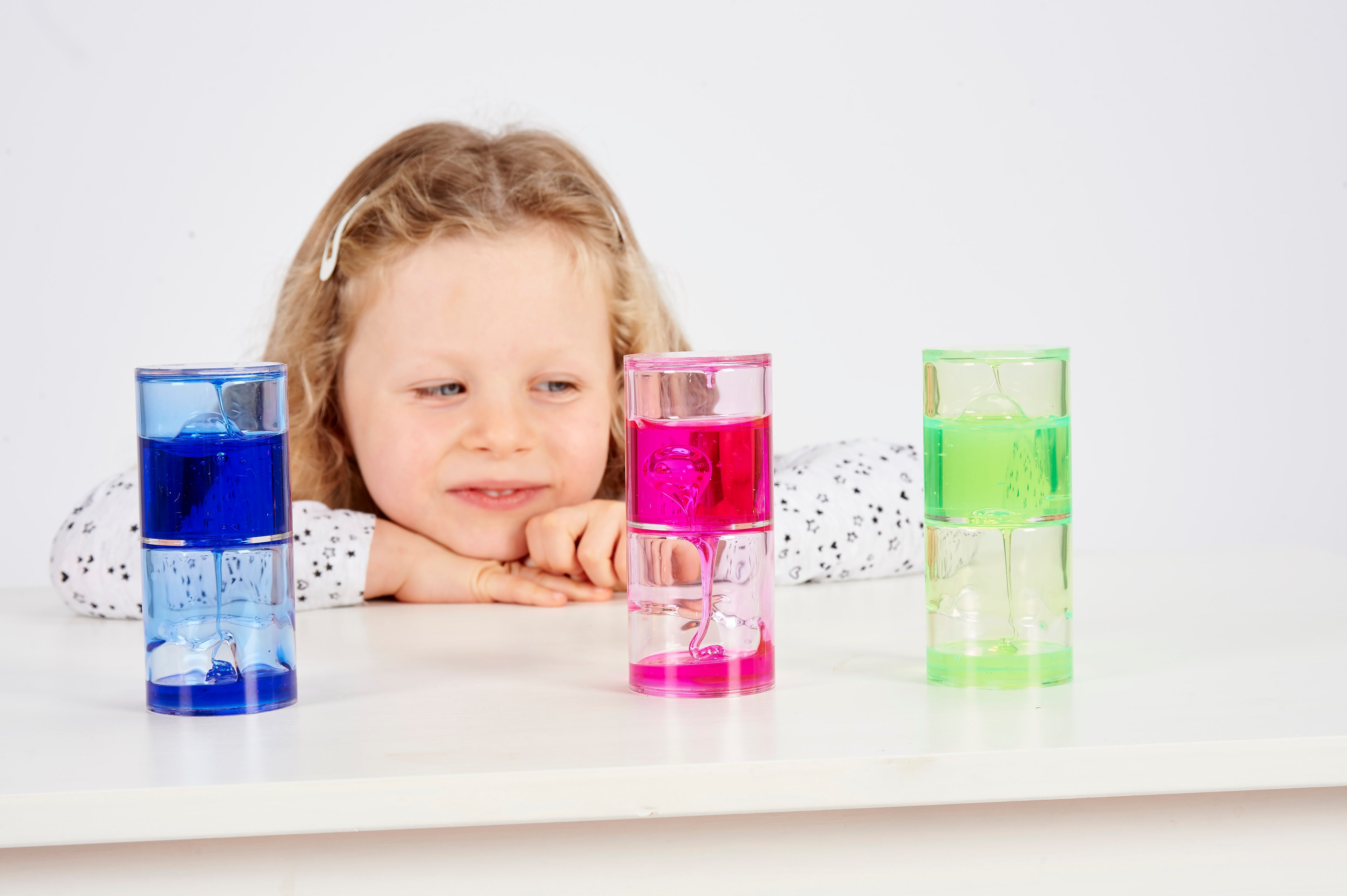 Ooze tube set with blue, pink, and green translucent tubes on tabletop