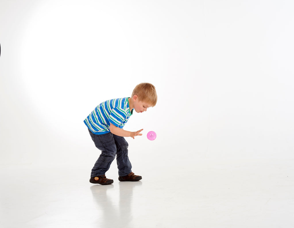 Purple glitter sensory ball in a child's hand during play