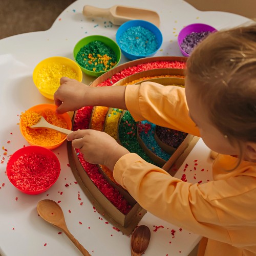 Sensory rice activity set with colorful rice in bowls