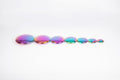 Iridescent rainbow steel buttons set of 7, flat round discs in a line