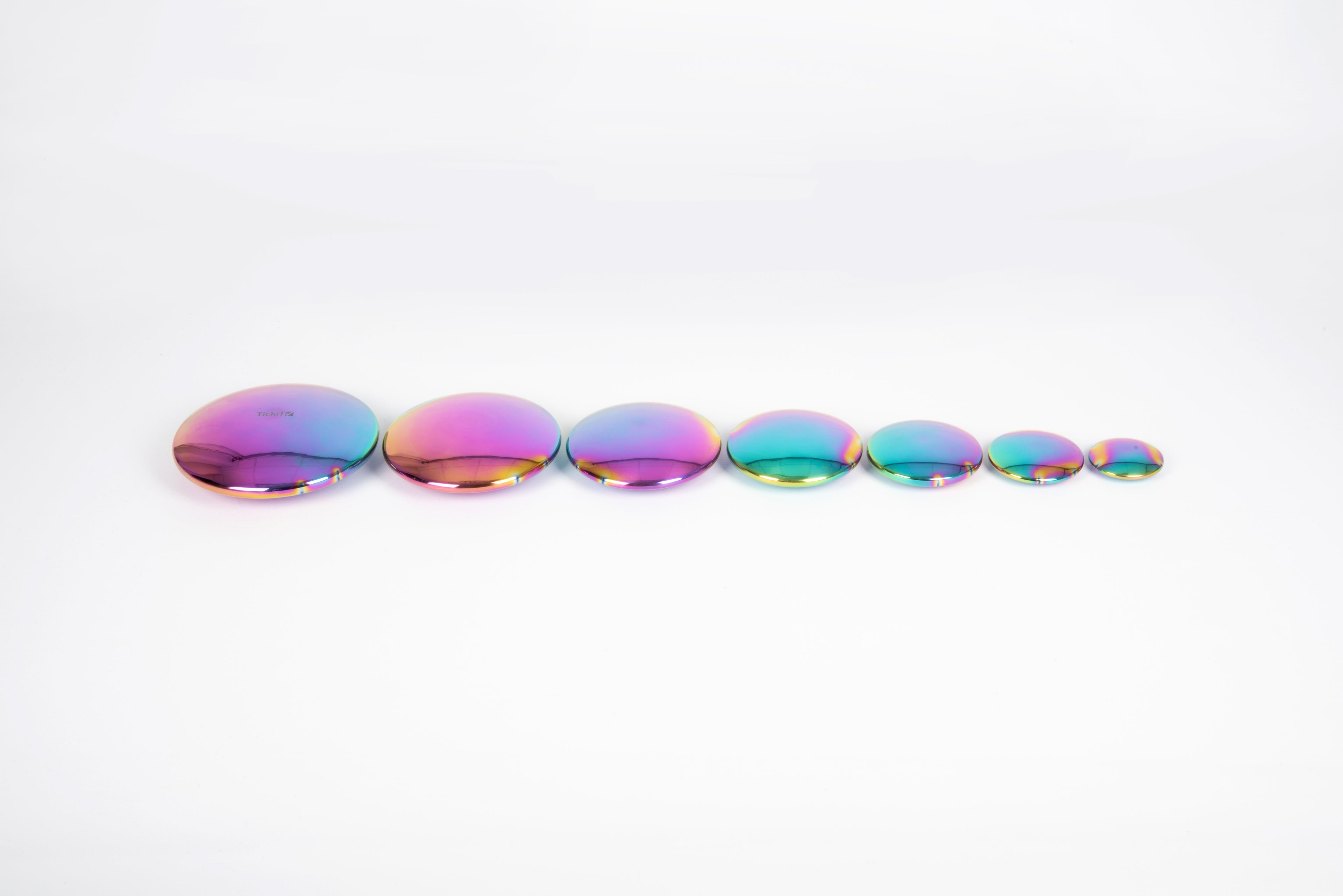 Iridescent rainbow steel buttons set of 7, flat round discs in a line