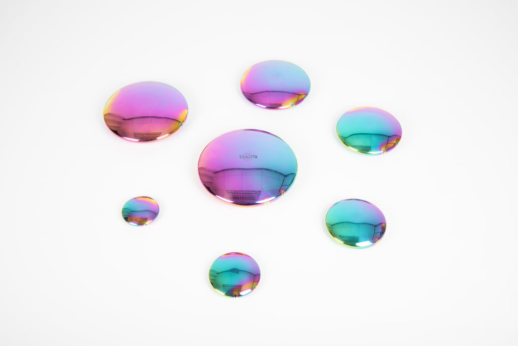 Iridescent rainbow steel buttons set of 7, round discs arranged in a loose circle