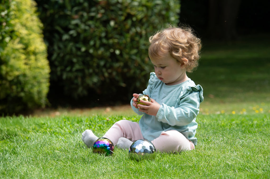 Iridescent metallic mosaic sensory balls in a child’s hands, 3-ball set
