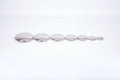 Seven round silver sensory metal buttons in a straight row