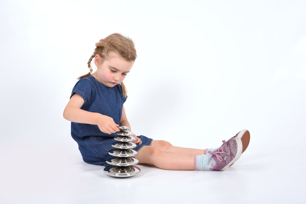 Seven round silver sensory metal buttons with a tall stacked base and loose pieces