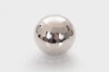 Reflective silver steel tumble ball with faceted mirrored surface