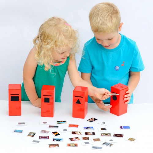 Children playing with a shape posting game: red mailboxes and photo cards