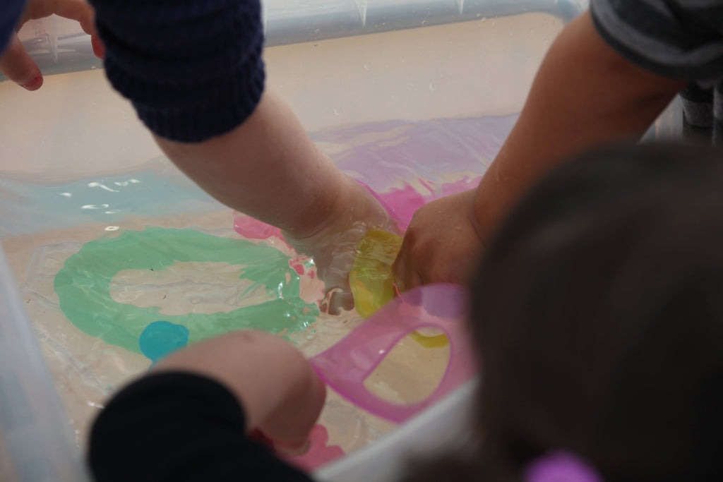 Green dot number tiles being placed on a play board by hands