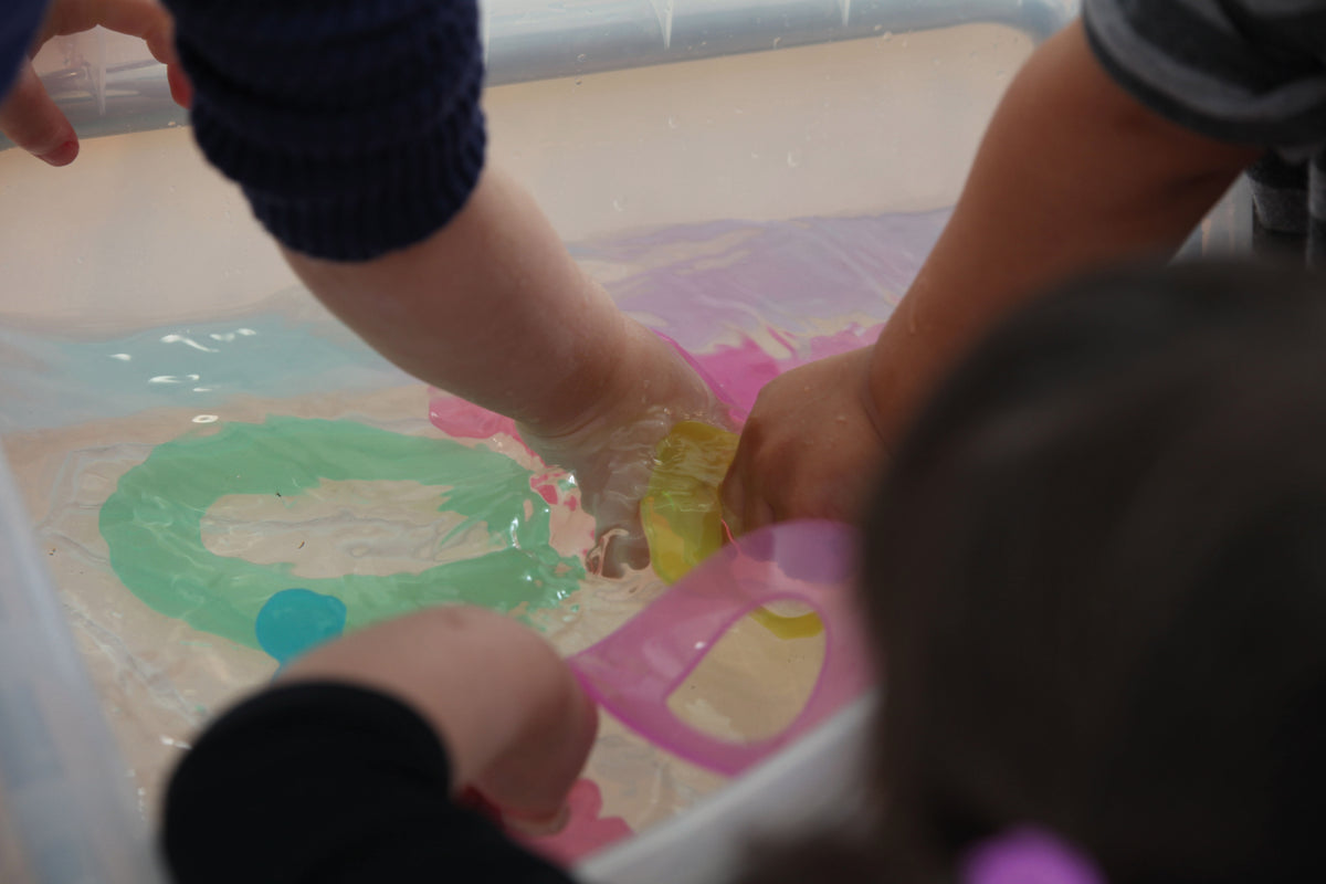 Green dot number tiles being placed on a play board by hands