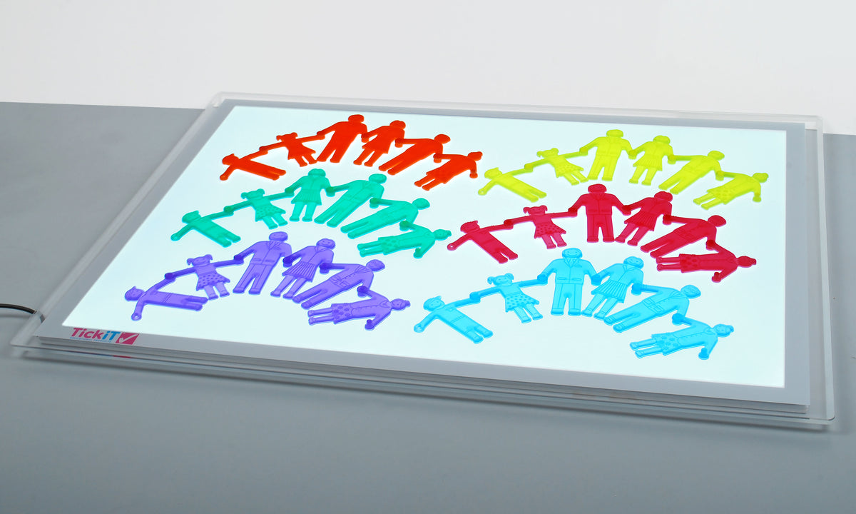 Colorful plastic people puzzle pieces on a clear tabletop board, assorted poses