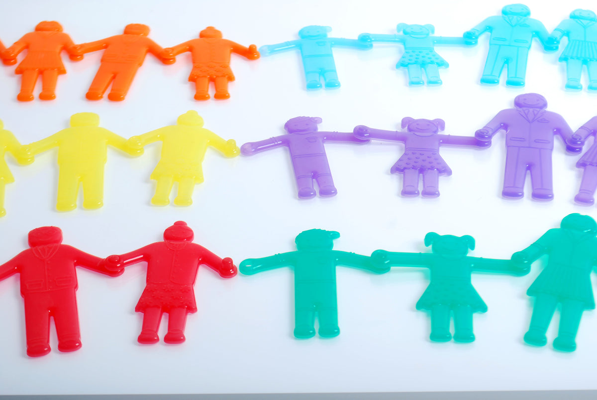 Rows of colorful connected plastic people toy figures in bright rainbow colors