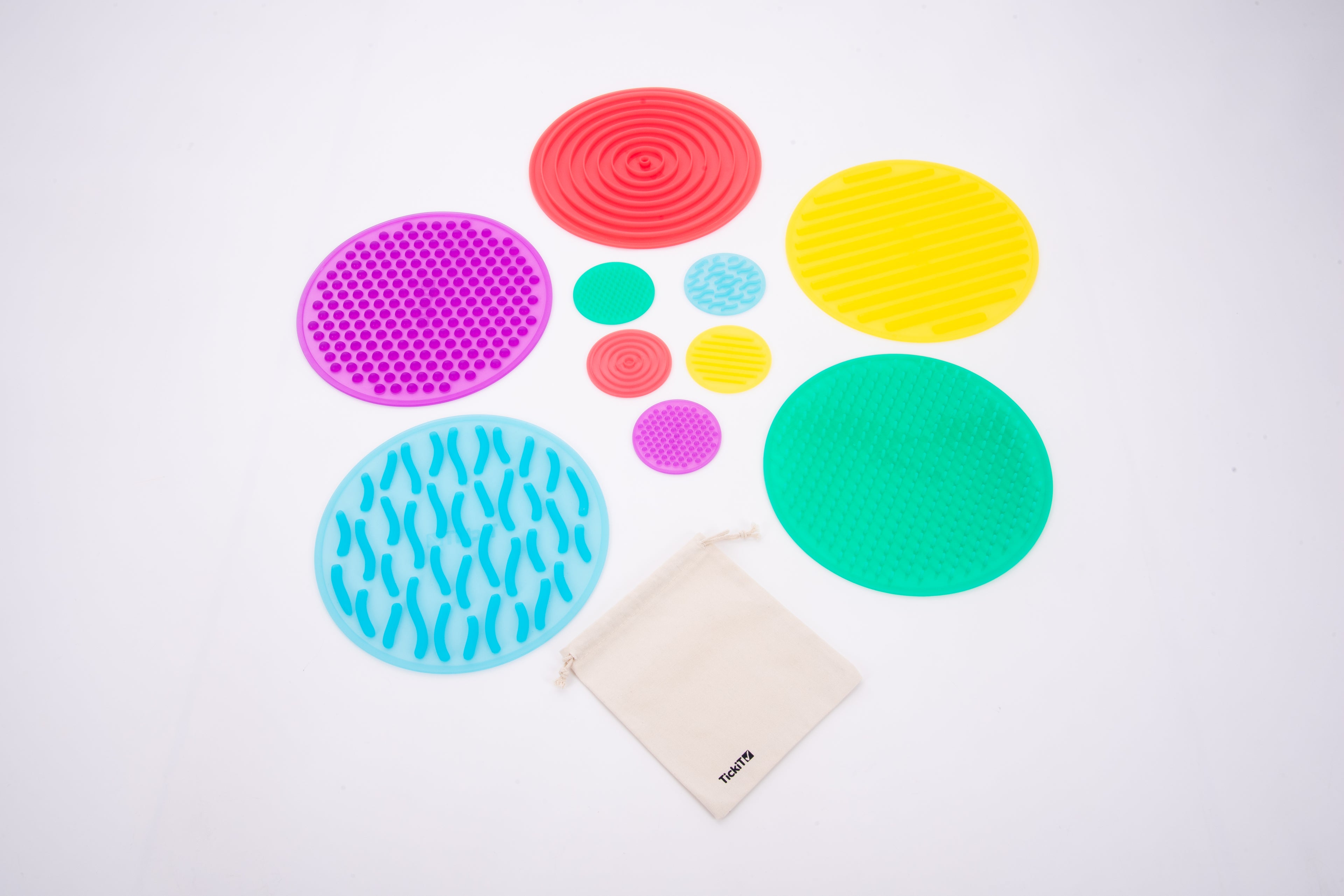 Assorted round textured sensory circles with a small beige pouch