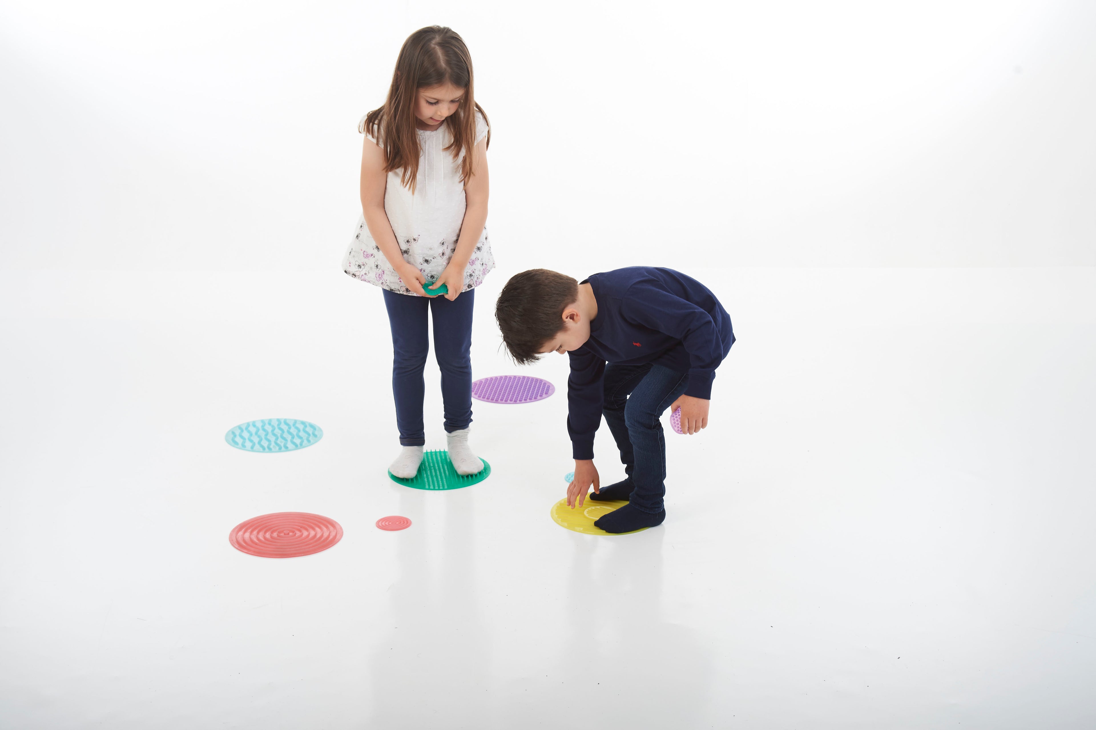 Colorful sensory stepping circles for kids, scattered on the floor
