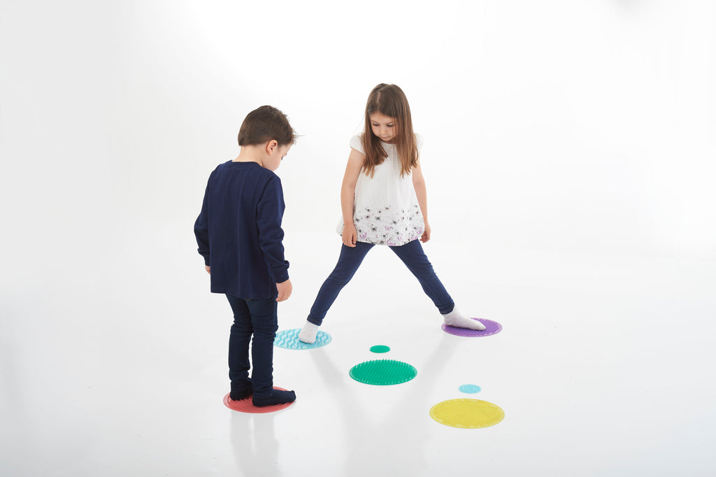 Assorted sensory circles on the ground during a kids play activity