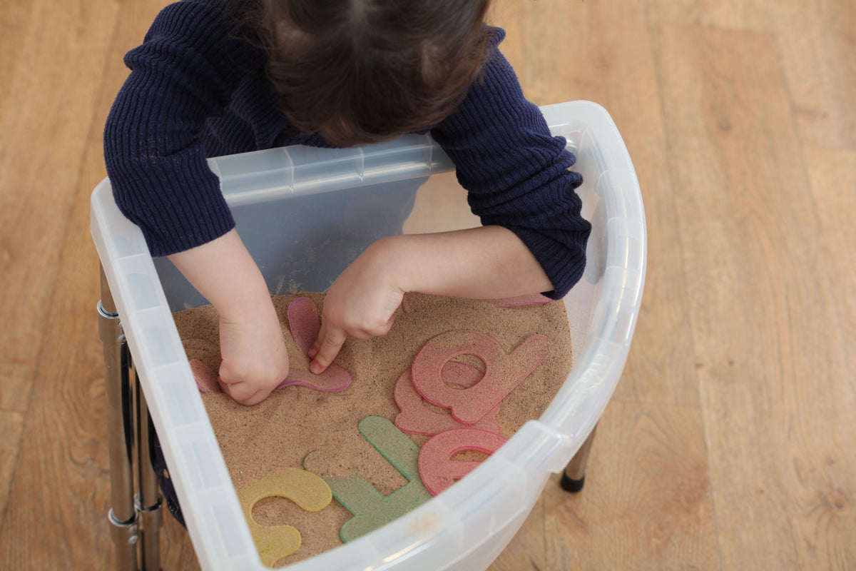 Alphabet tracing tray with large letter foam pieces pressed by child's hands