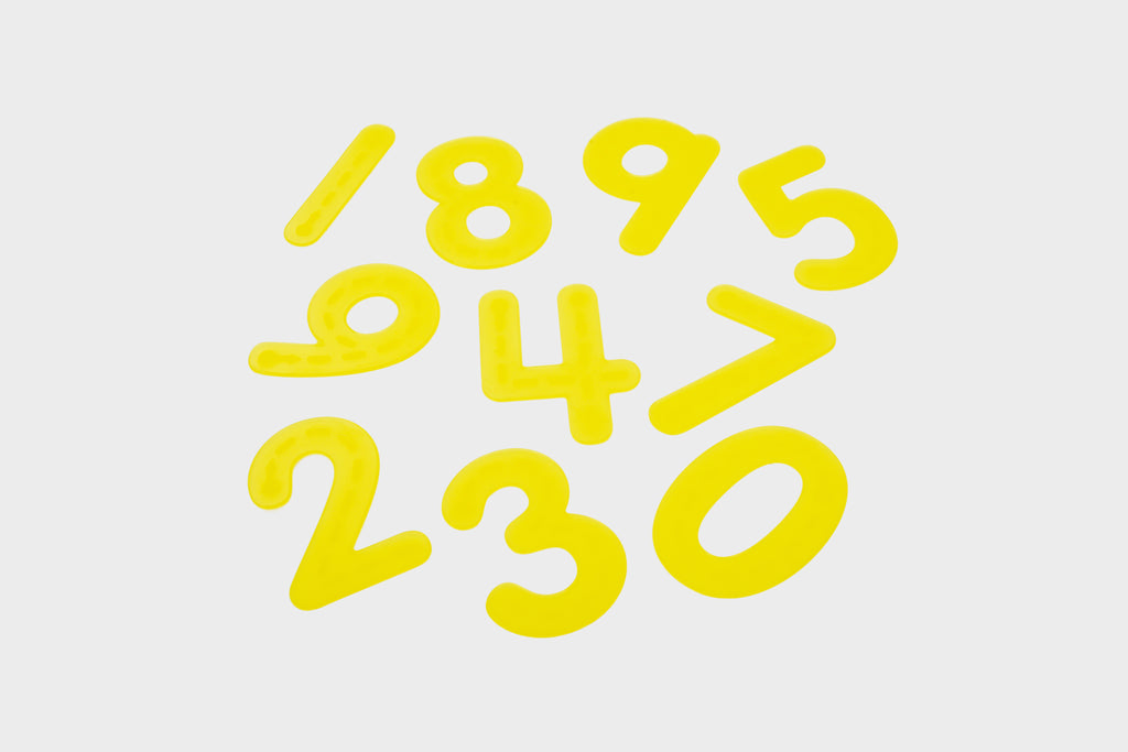 Yellow foam trace numbers digits 0–9 laid out on a light background
