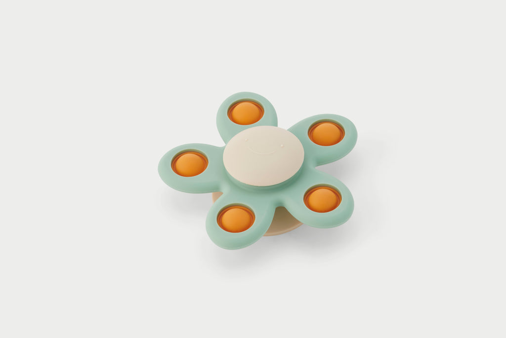 Flower spinner toy with teal petals and orange centers, white hub