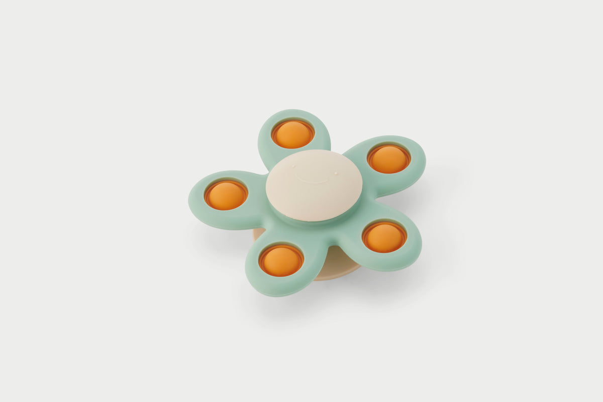 Flower spinner toy with teal petals and orange centers, white hub