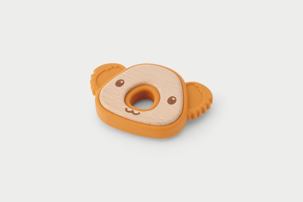 Koala-shaped silicone teether with light fabric insert, round teething ring, and orange grips